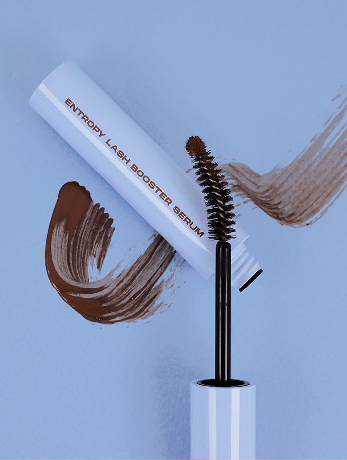 A tube of Entropy Lash Booster Serum with an open brush applicator