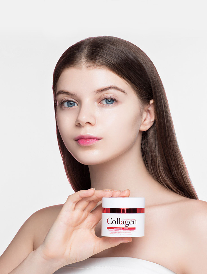 a young woman with flawless skin holding a jar of DERMAFIX Collagen Tension Up Cream, showcasing the product's ability to enhance skin firmness and hydration. The cream container, prominently displayed, highlights its collagen-rich formula for anti-aging and moisturizing benefits.