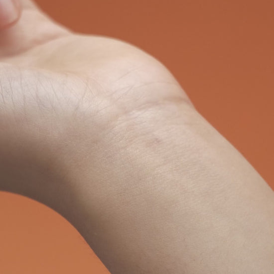 Applying fig scent balm to the wrist