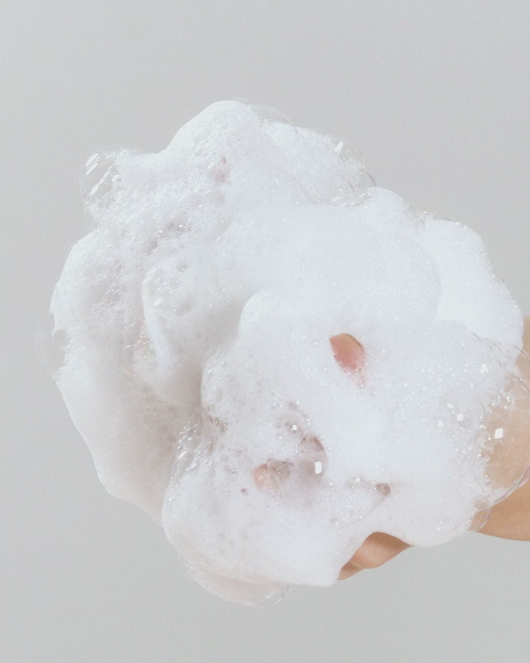 Close-up of white, fluffy foam from Amber 528 Hand & Body Wash