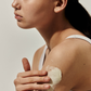 gently rubbing Arencia Fresh Cleanser on their arm